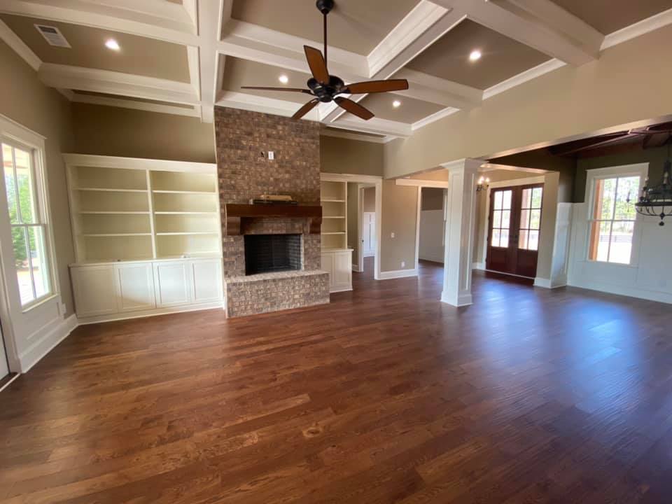 Photo of Boone House, Oconee, GA, with trey ceilings, hardwood floors, multiple built in bookcases and stone fireplace