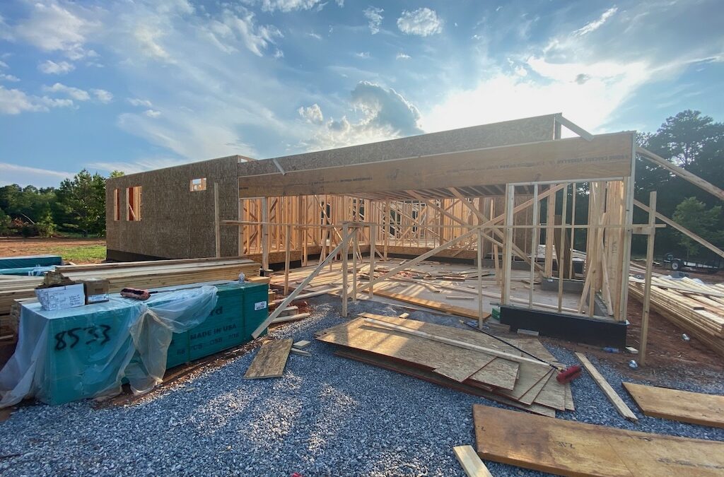 Photo of home under construction with early stages of framing