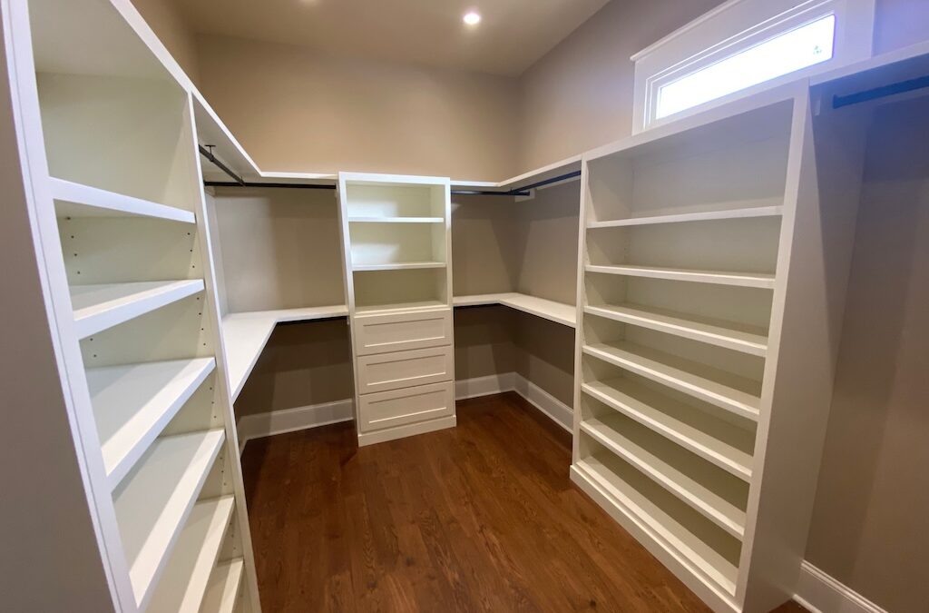 Photo of master bedroom closet with built in shelving