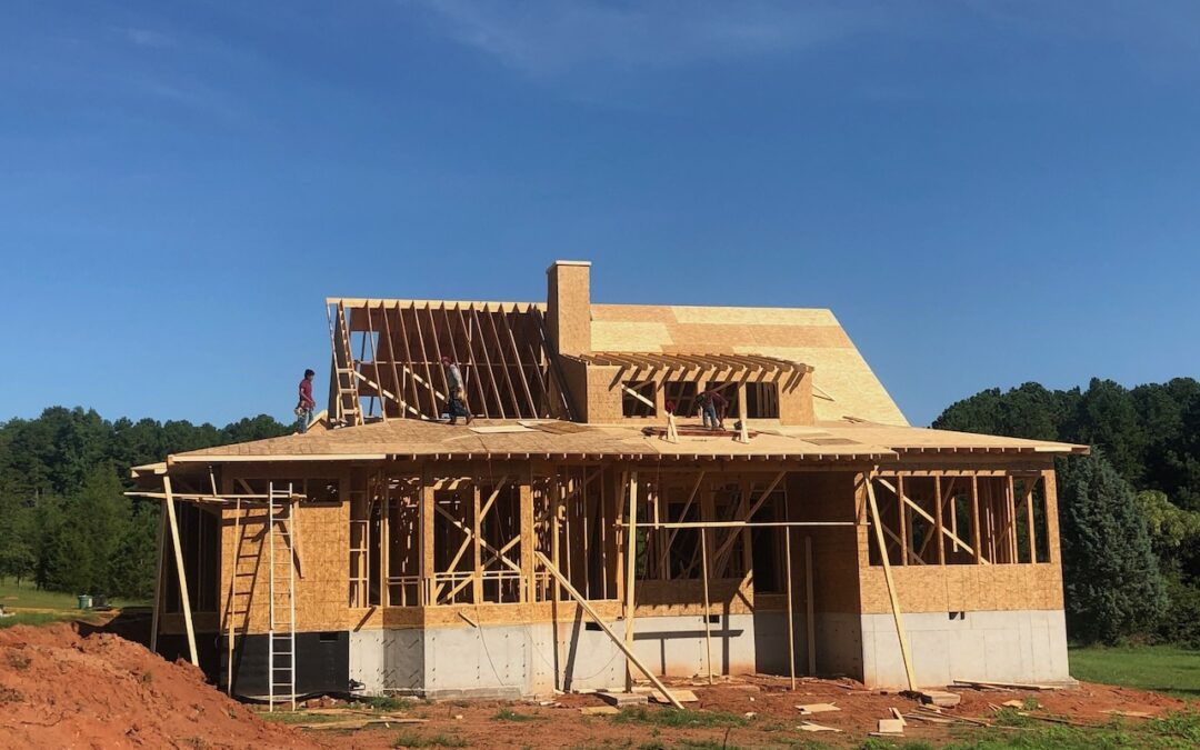 Photo of home under early construction in the framing process